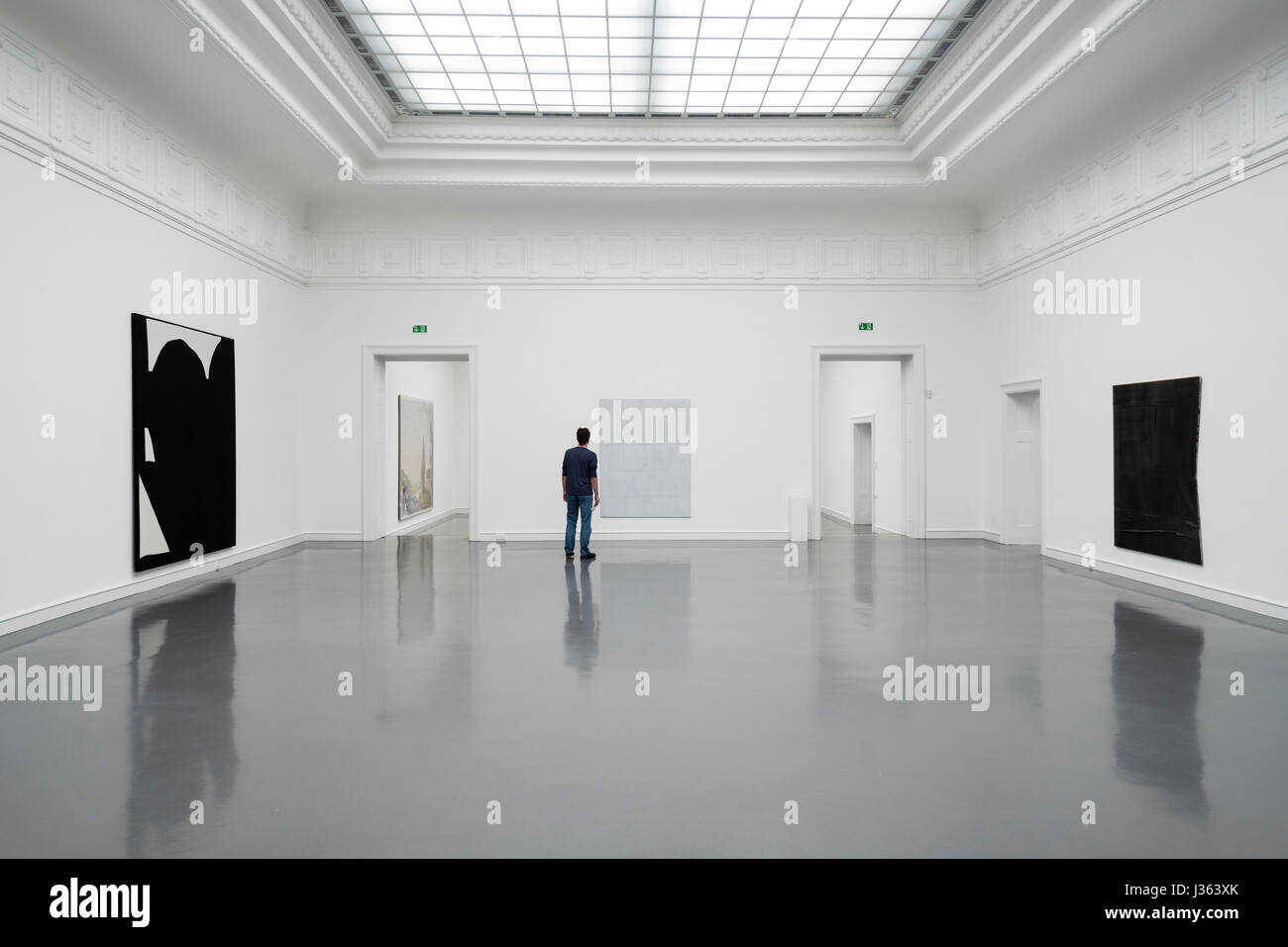 Man looking at painting by Sergej Jensen at Kunsthalle in Baden-Baden,  Baden-Wurttemberg, Germany. Stock Photo