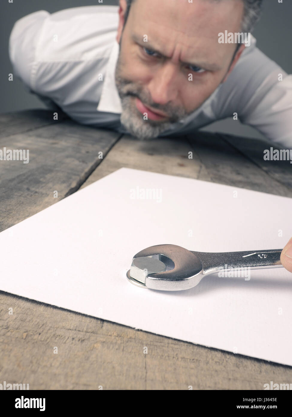 Business concept image with a concluding contract using a wrench and nut Stock Photo