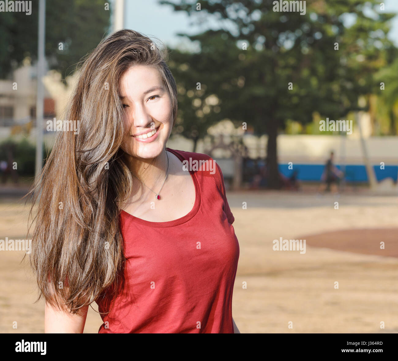 Happy Woman With A Cute Smile Lined Up To The Left With Blank Space On The Side White Teeth Light Brown Hair Wearing A Red Shirt And A Necklace Stock Photo Happy Woman With A Cute Smile Lined Up To The Left With Blank Space On The Side White Teeth Light Brown Hair Wearing A Red Shirt And A Necklace Stock Photo