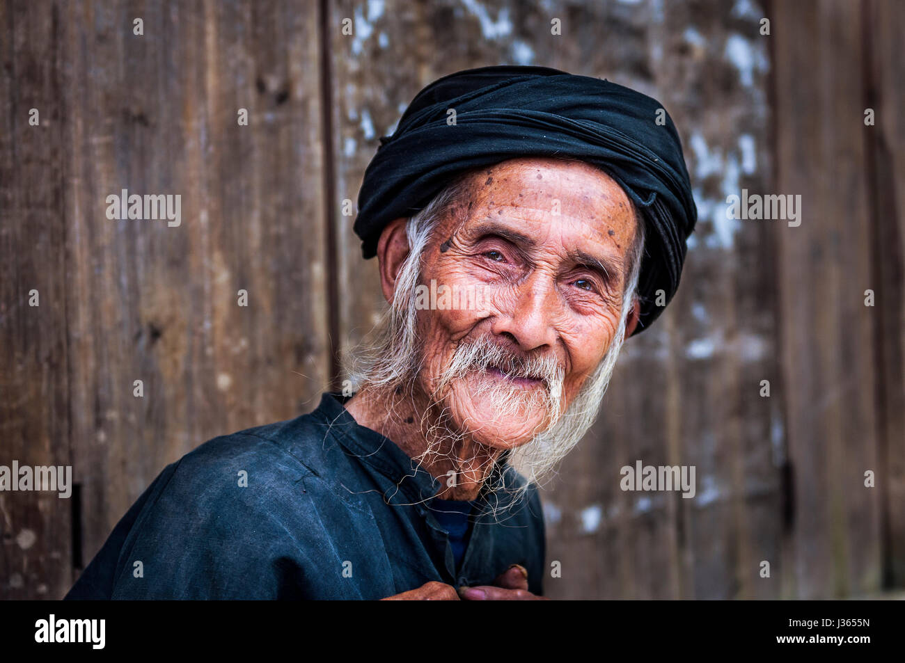 Old Chinese man wearing traditional clothes in Dazhai, Guangxi, China; Concept for travel in China Stock Photo
