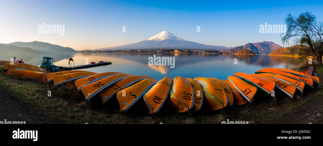 Panorama of mountain fuji with reflection and group of orange boat in foreground lake kawaguchi japan Stock Photo