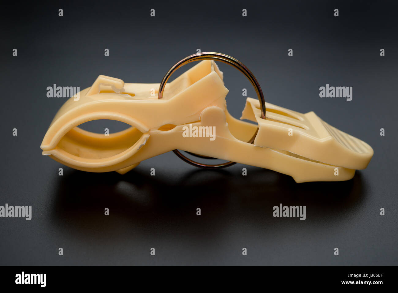 side view broken clothespin on a black background Stock Photo Alamy