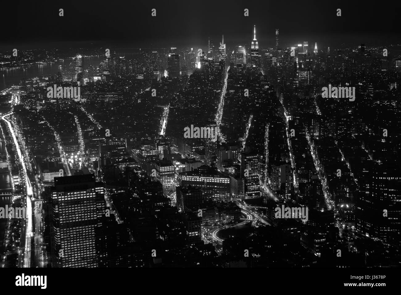 Buildings and streets of the night in New York City. Aerial view. Black ...