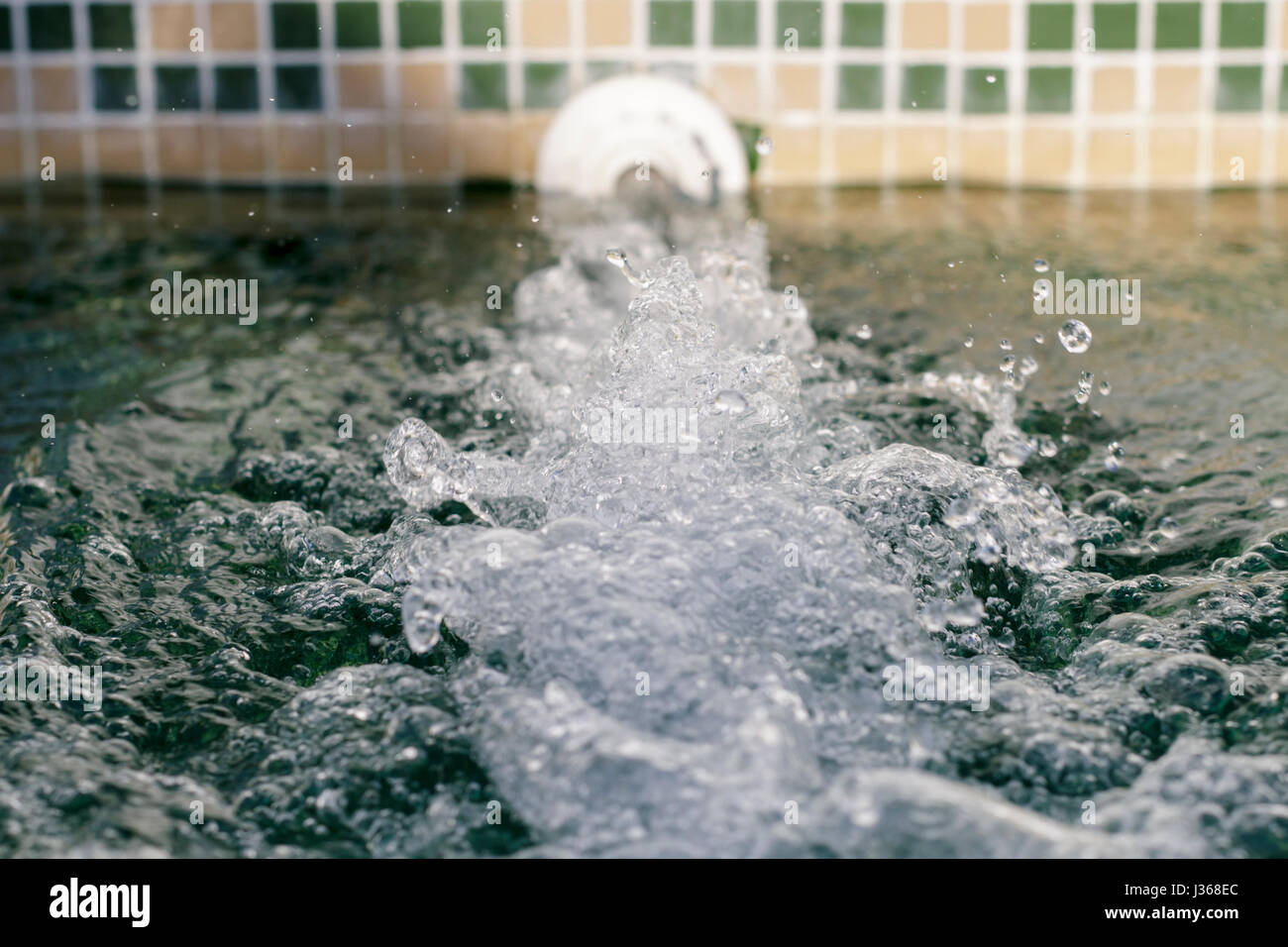 Front view of inflowing water jet into a pool Stock Photo - Alamy
