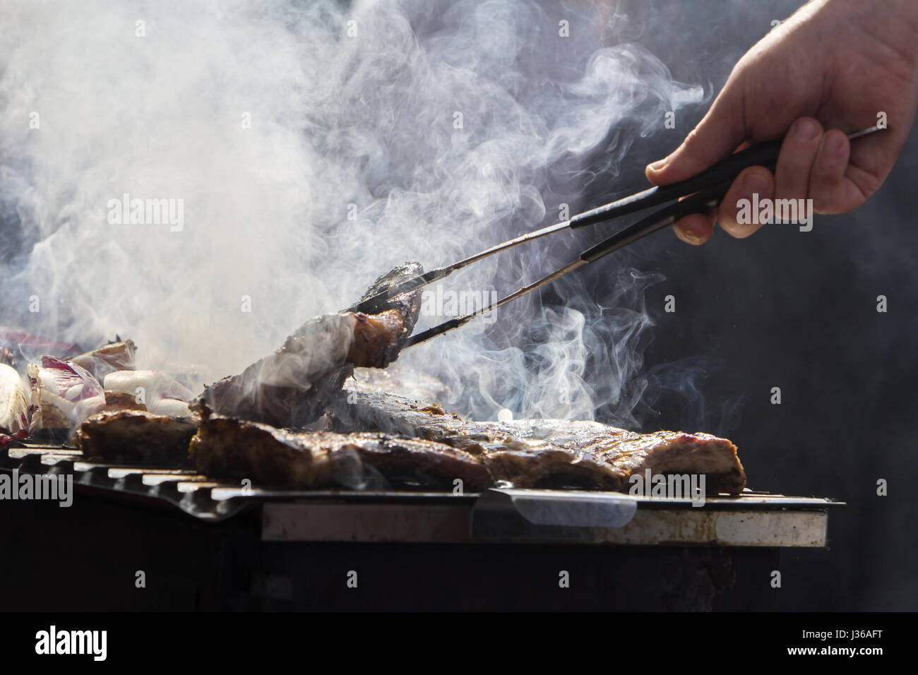 Grilled pork ribs and red chicory on the grill Stock Photo