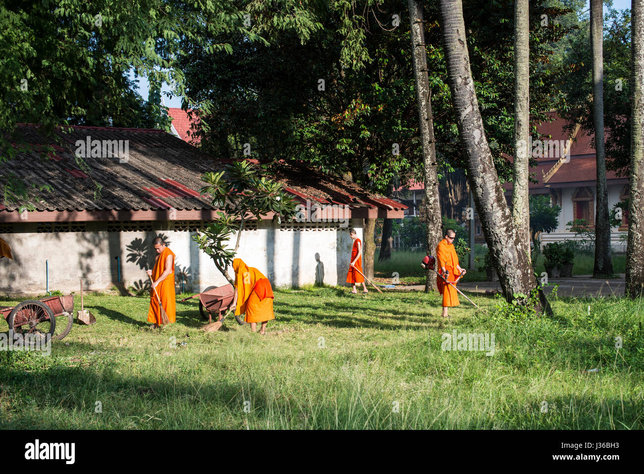 Monks sweeping, Vientiane Stock Photo