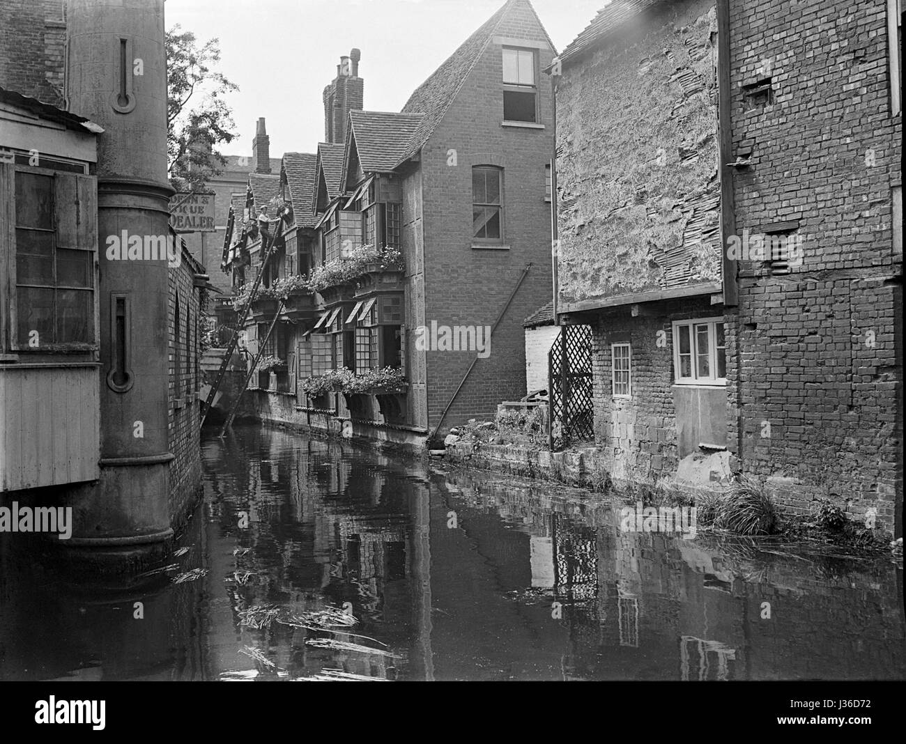 Buildings standing in the River Stour as it wanders through Canterbury and the district known as 'Canterbury Weavers'. Taken in 1905 Stock Photo