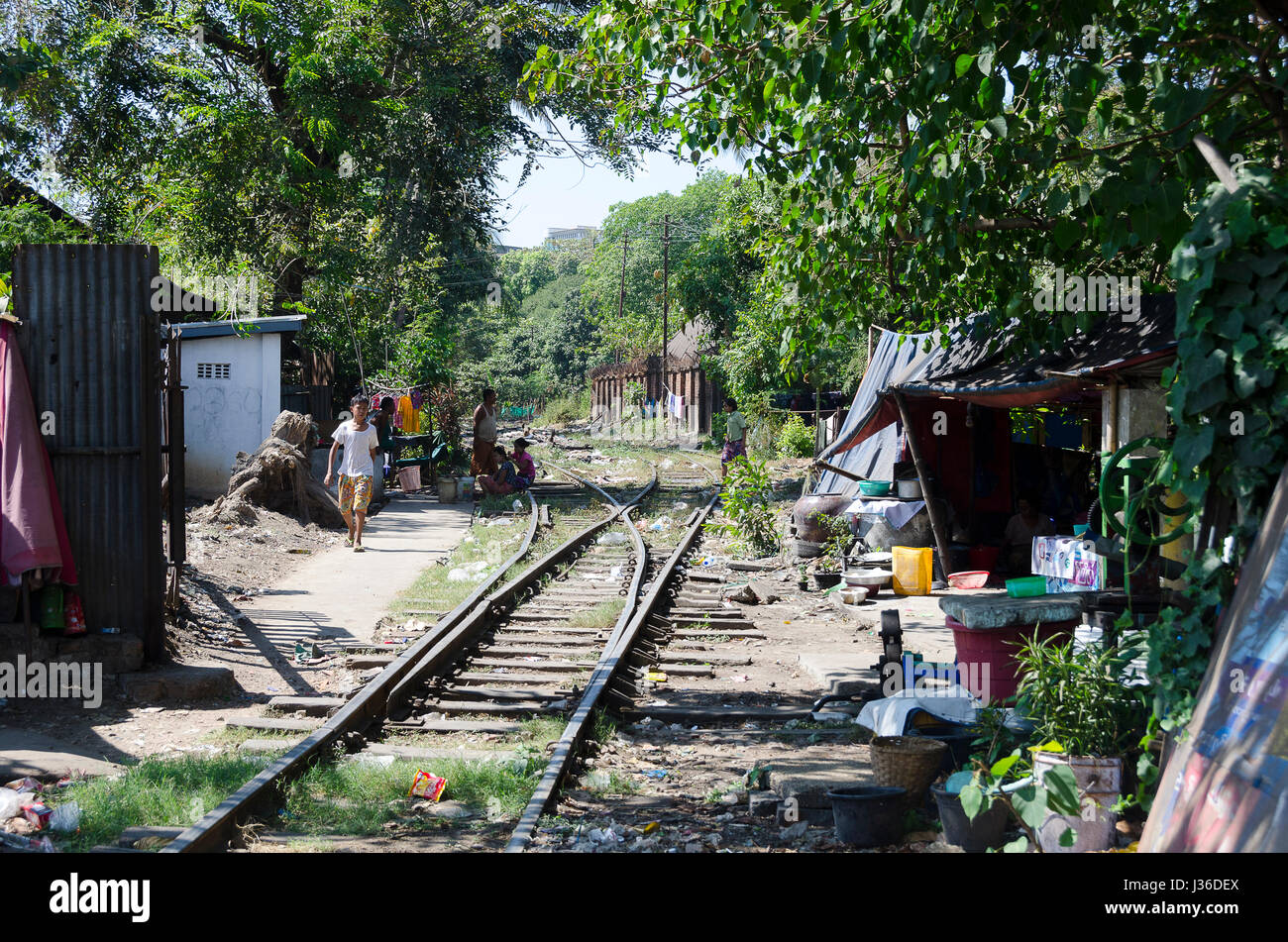 Railway branch line in city, with shacks alongside, Yangon, Myanmar Stock Photo