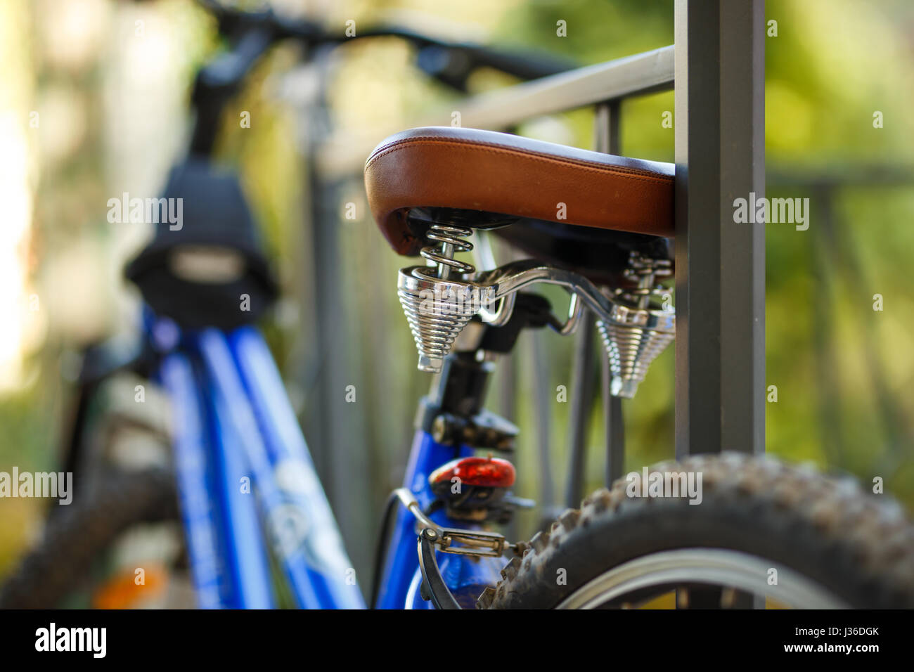 Brown leather comfortable bicycle saddle, closeup photo. Stock Photo