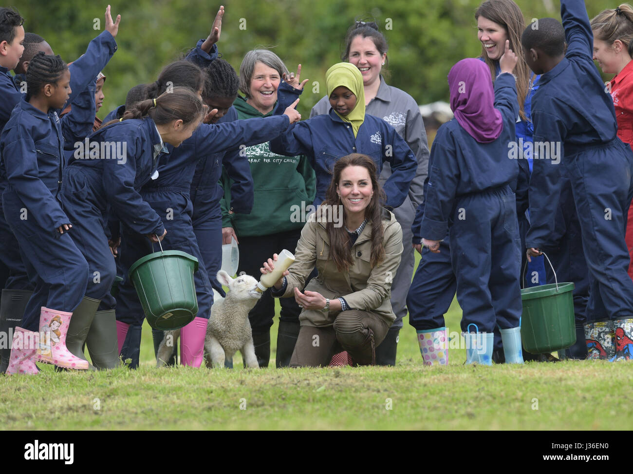 The Duchess of Cambridge in a field with school children during a visit to the Farms for City Children charity in Gloucester, where she saw their work giving young people from inner cities the chance to spend a week on a working farm. Stock Photo