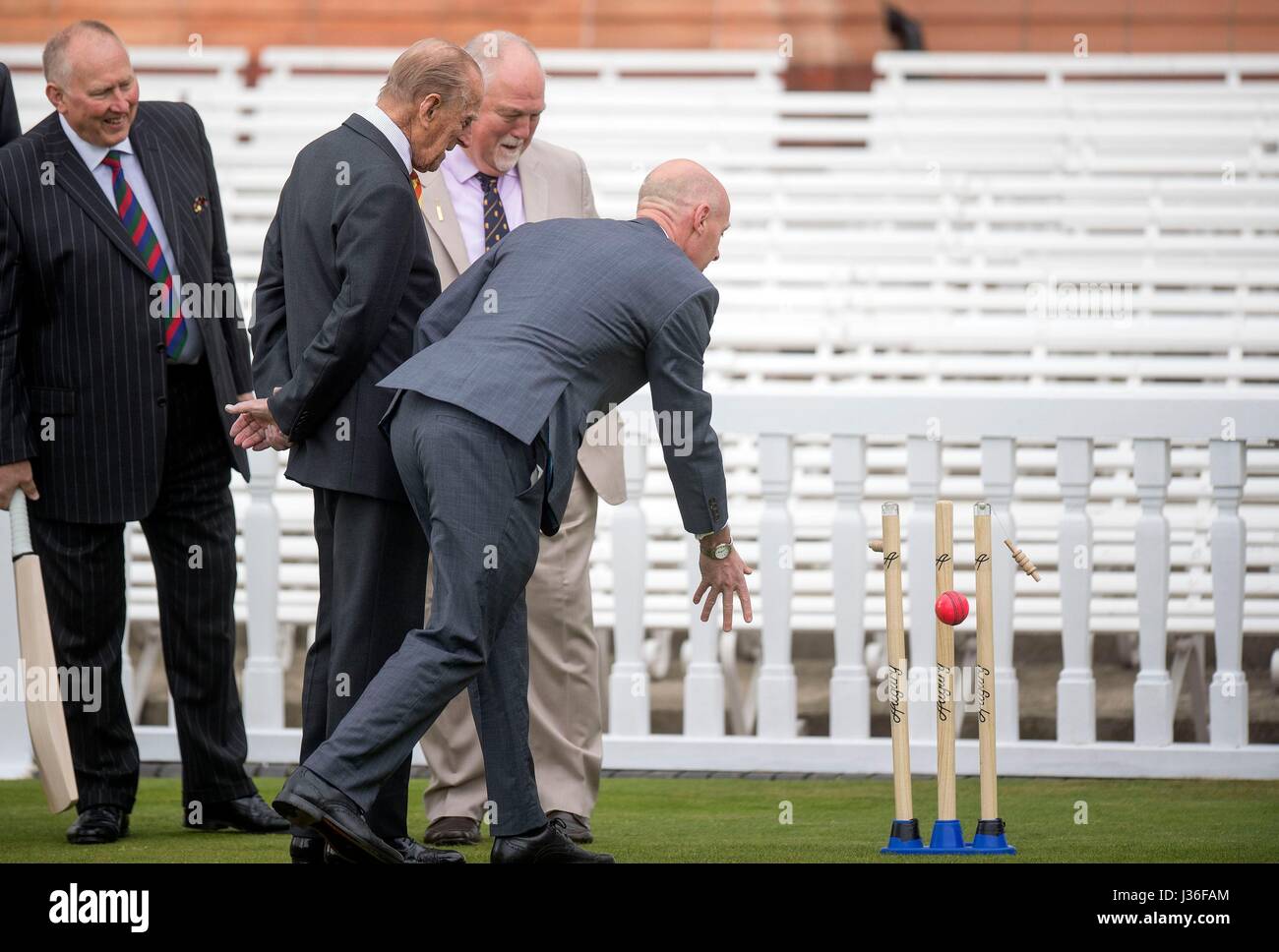 RETRANSMITTING CORRECTING NAME FROM JOHN STEPHENSON TO FRASER STEWART (Left-right) Graham Monkhouse, the Duke of Edinburgh and Mike Gatting watch as Marylebone Cricket Club's Laws of Cricket Manager Fraser Stewart (right) bowls towards self retracting bails at Lord's Cricket Ground in London. Stock Photo