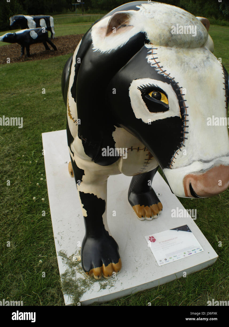 MK Lion mascot pretending to be a cow Stock Photo