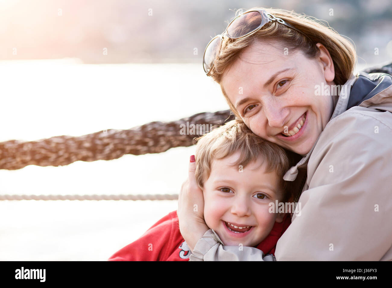near 4 year old kid smiling and enjoy holiday in italian seatown with his mother Stock Photo