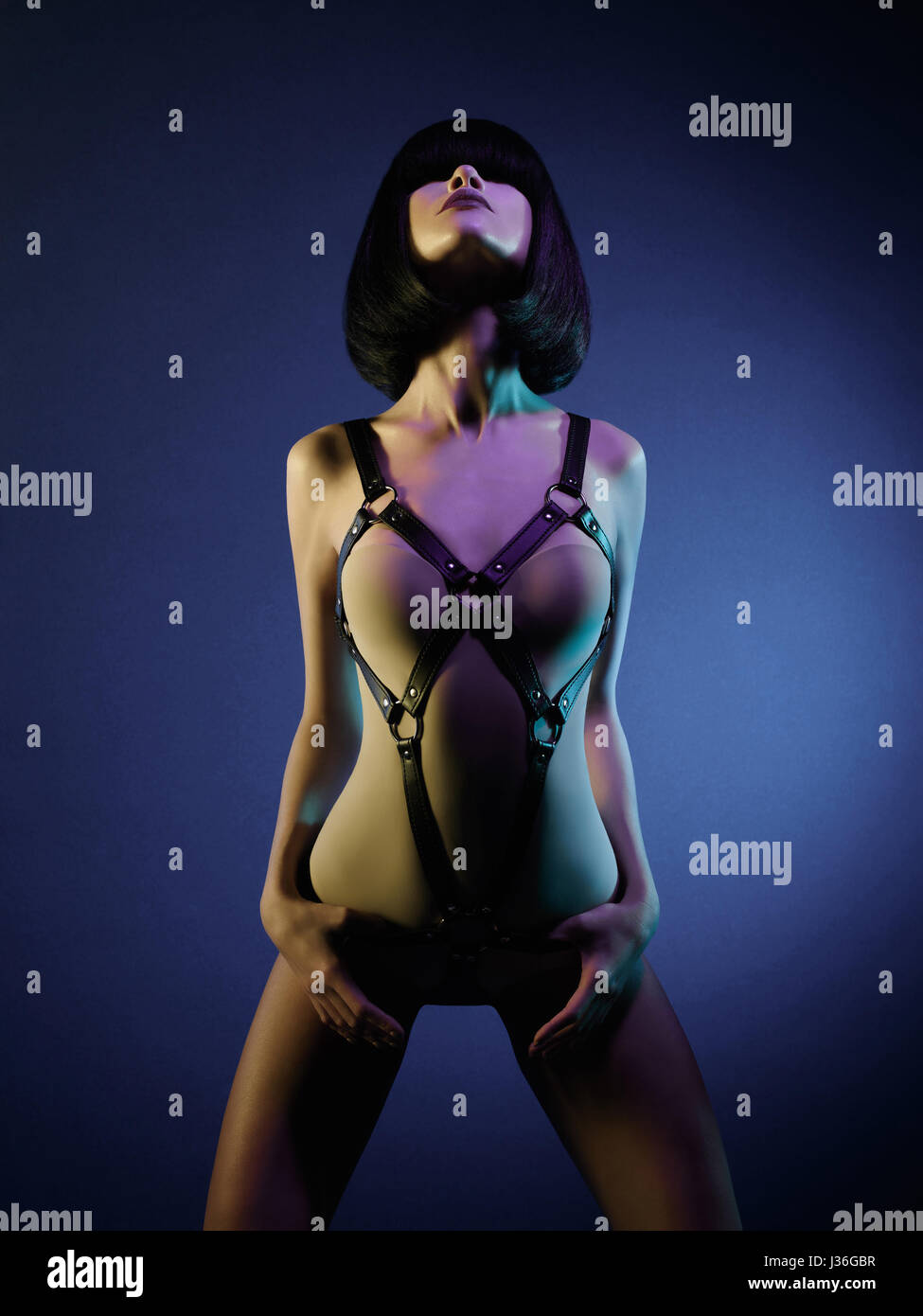 sexy young woman in erotic fetish wear dancing striptease in nightclub.  Beautiful nude body of sensuality elegant lady Stock Photo - Alamy