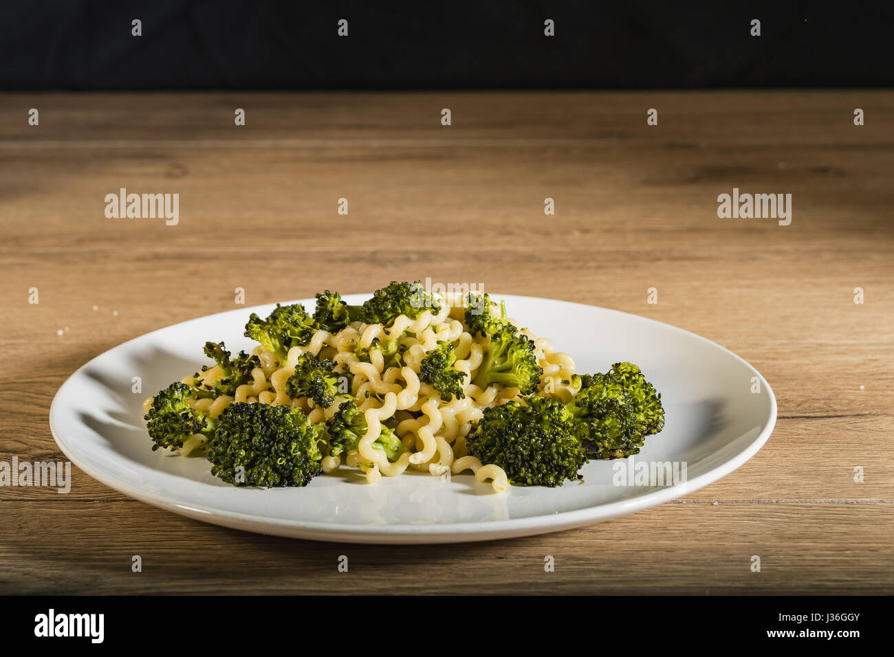 Long pasta dish with broccoli from below Stock Photo