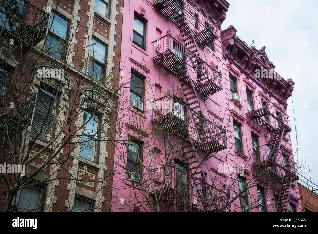 Pink apartment building with fire escapes, New York City Stock Photo ...