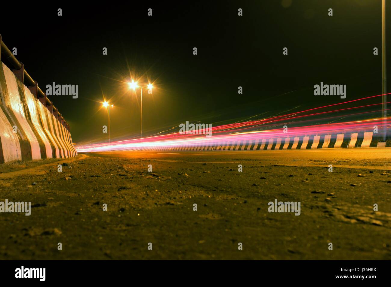 Night photography of the road transportation in the capital city of New Delhi, India. Freeway in low light photography Delhi Photography - Image Stock Photo