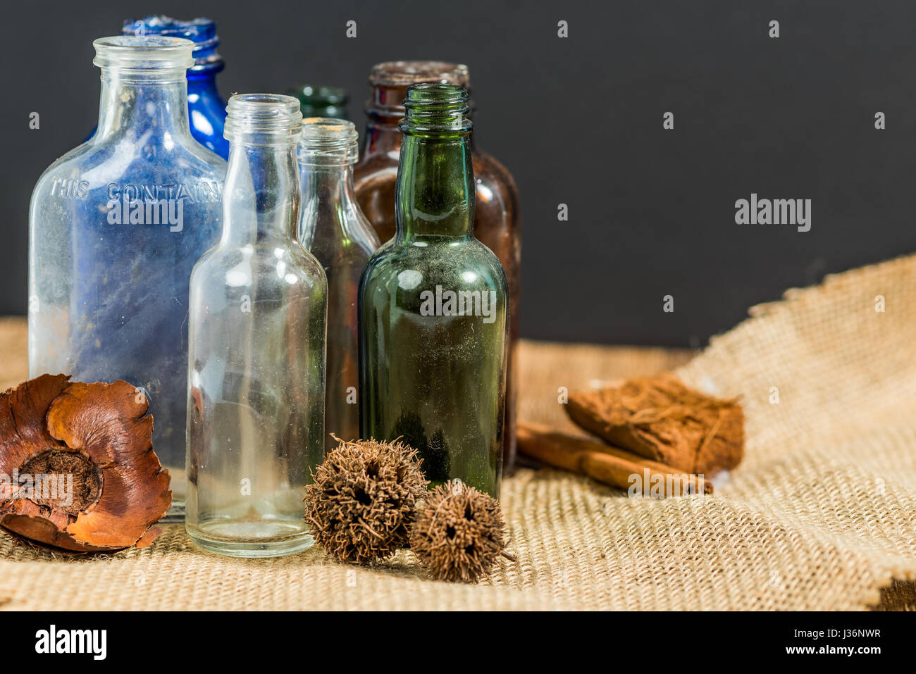 Vintage bottles in rustic setting Stock Photo