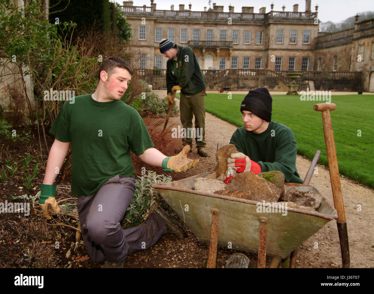 Tom Underwood (plain hat) and Ben Lewis who are inmates of Ashfield Young Offenders Institute working in Dyrham Park, with Nathan Bengey (striped hat) Stock Photo