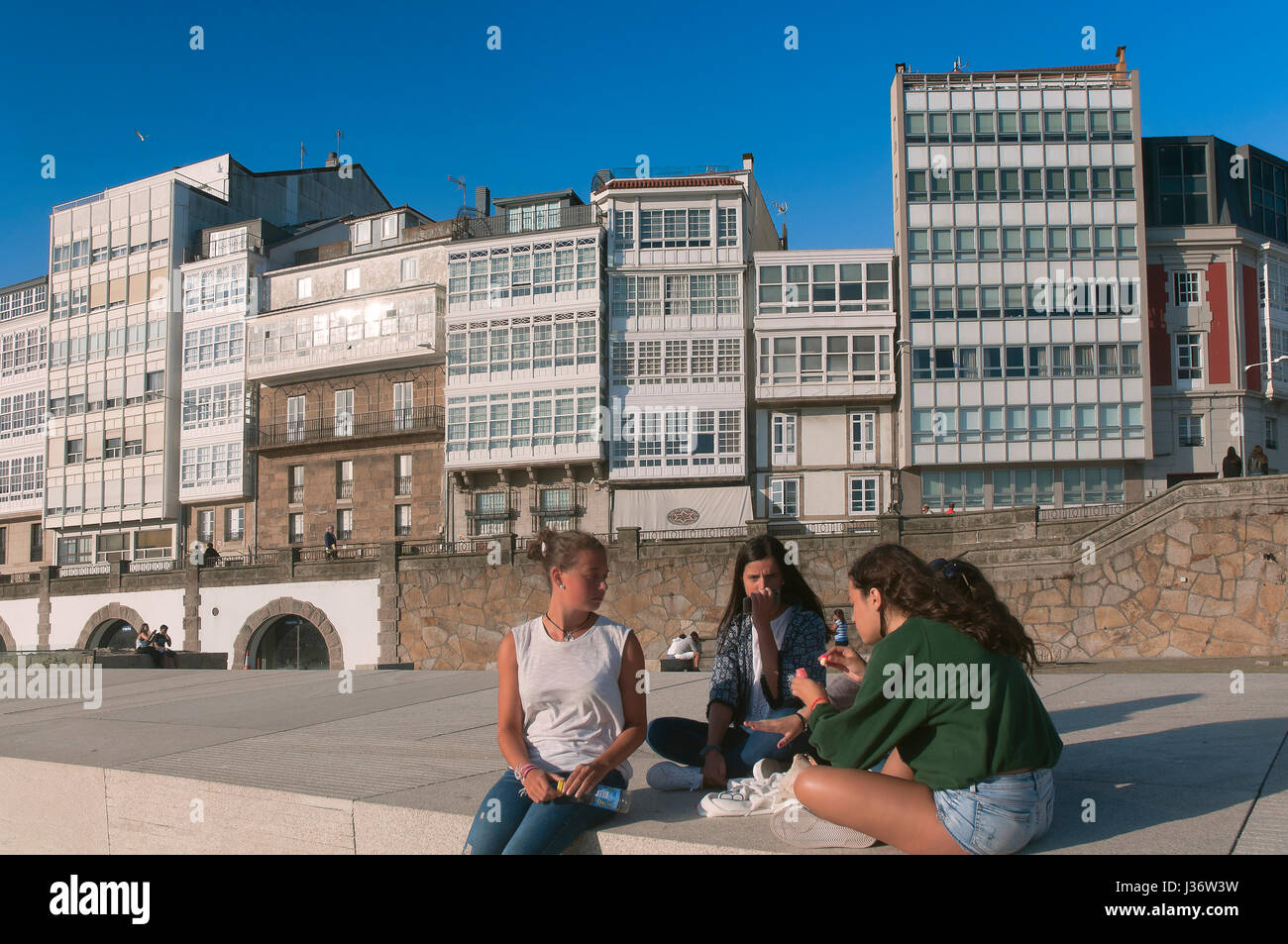 Group of girls next to the port, La Coruna, Region of Galicia, Spain, Europe Stock Photo