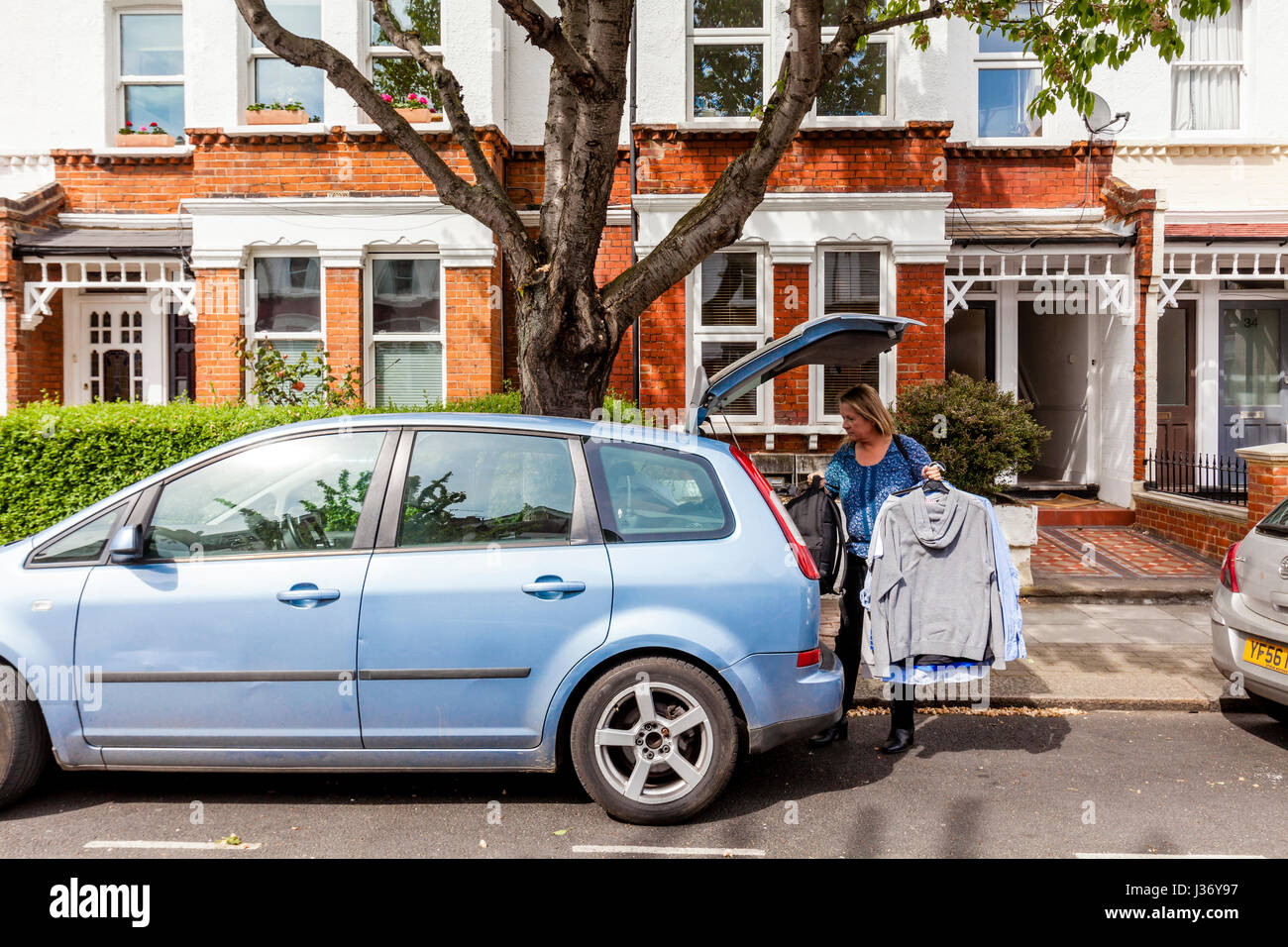 A Mother Helps Her Son Move Home, London, England Stock Photo