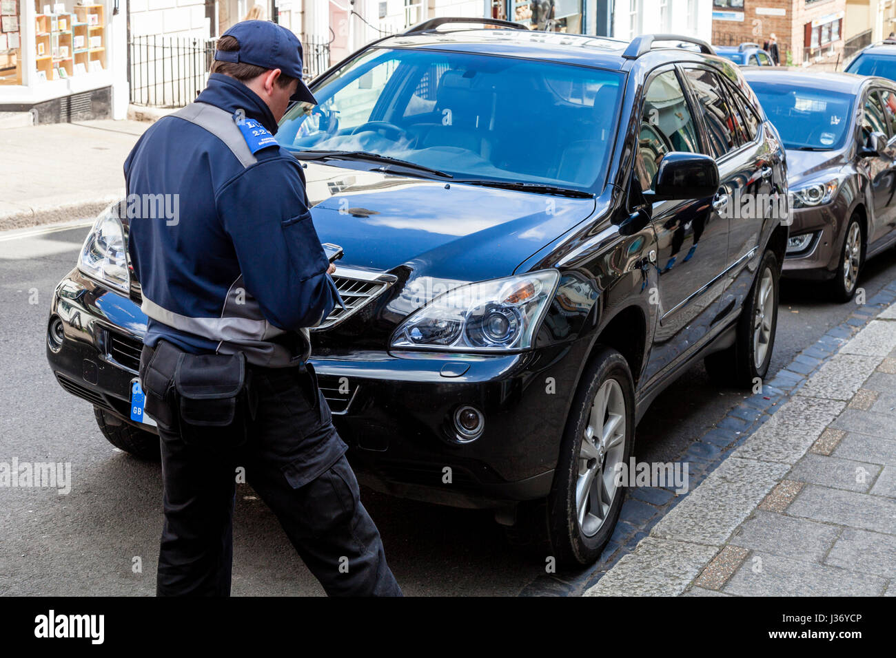 A Traffic Warden Taking Car Details, High Street, Lewes, Sussex, UK Stock Photo