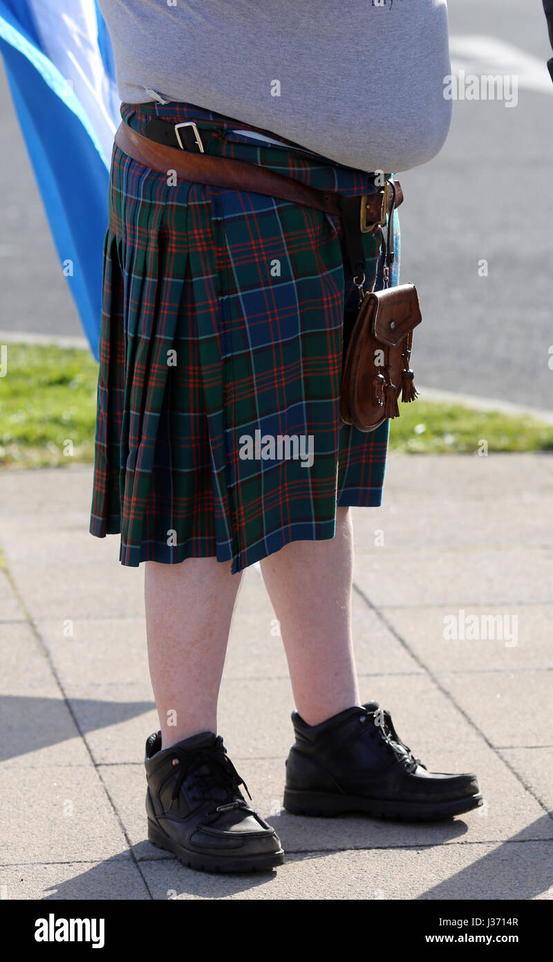 An overweight Scotsman wearing a tartan kilt leather sporran and a fat stomach depicting obesity Stock Photo