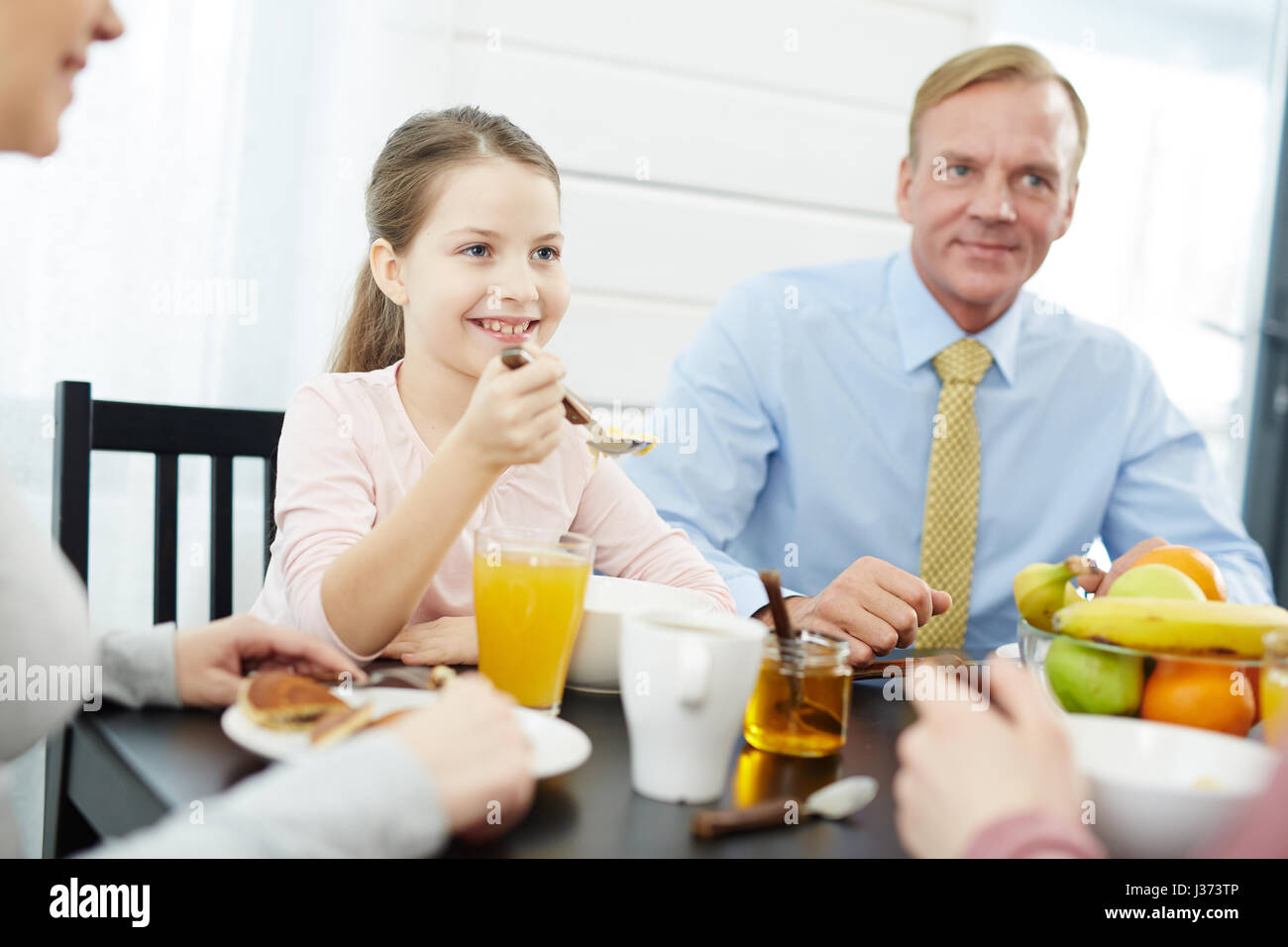 Members of Lovely Family Having Breakfast Stock Photo - Alamy