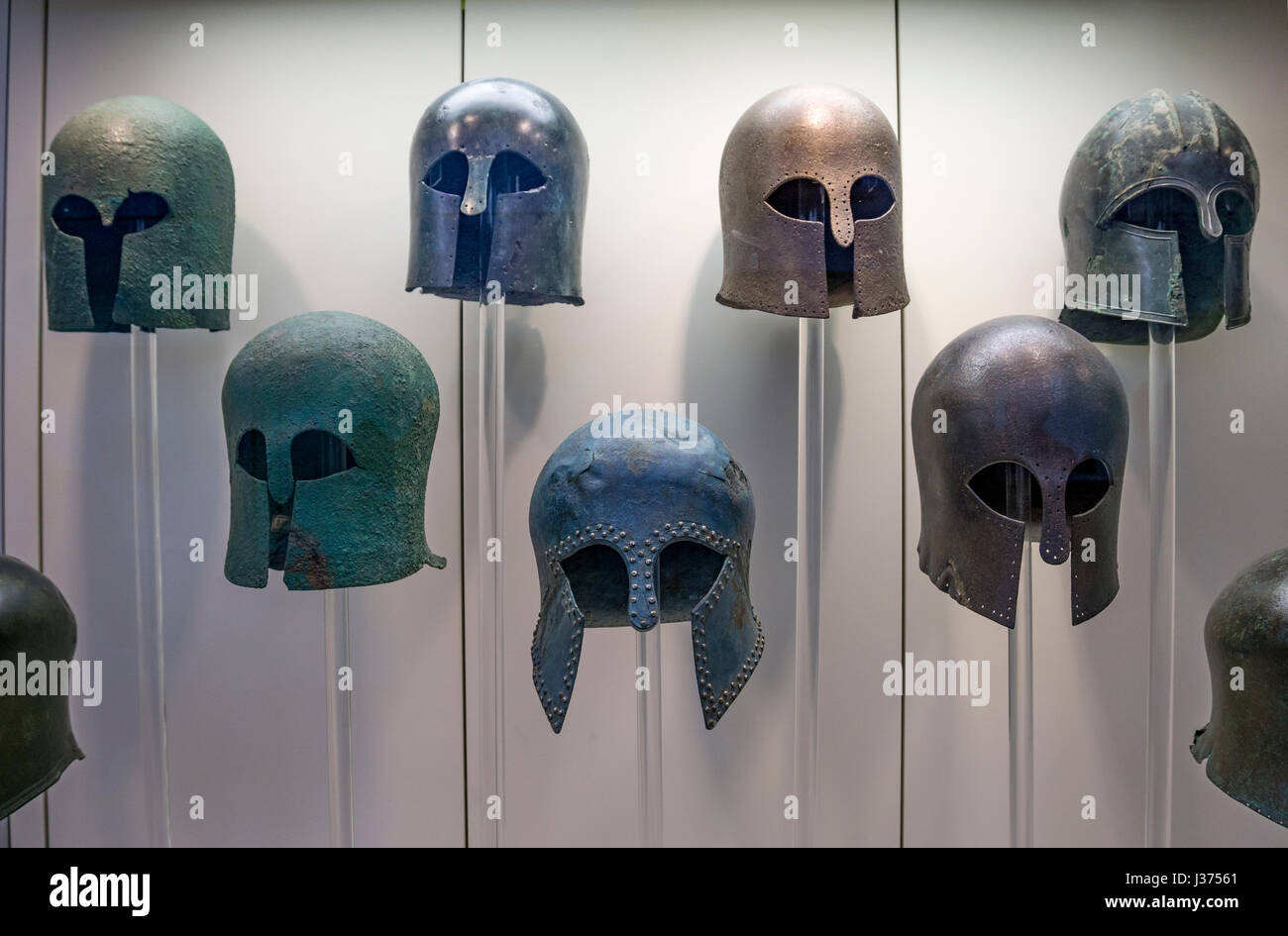 Early classical, Corinthian style, Bronze helmets in the Archaeological  museum, Ancient Olympia, Peloponnese, Greece. Stock Photo