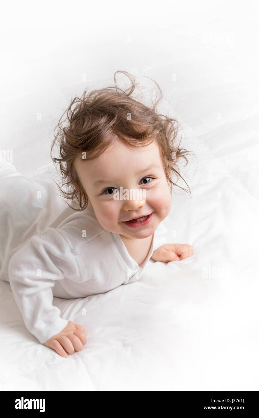 Baby girl looking at the camera and smiling Stock Photo