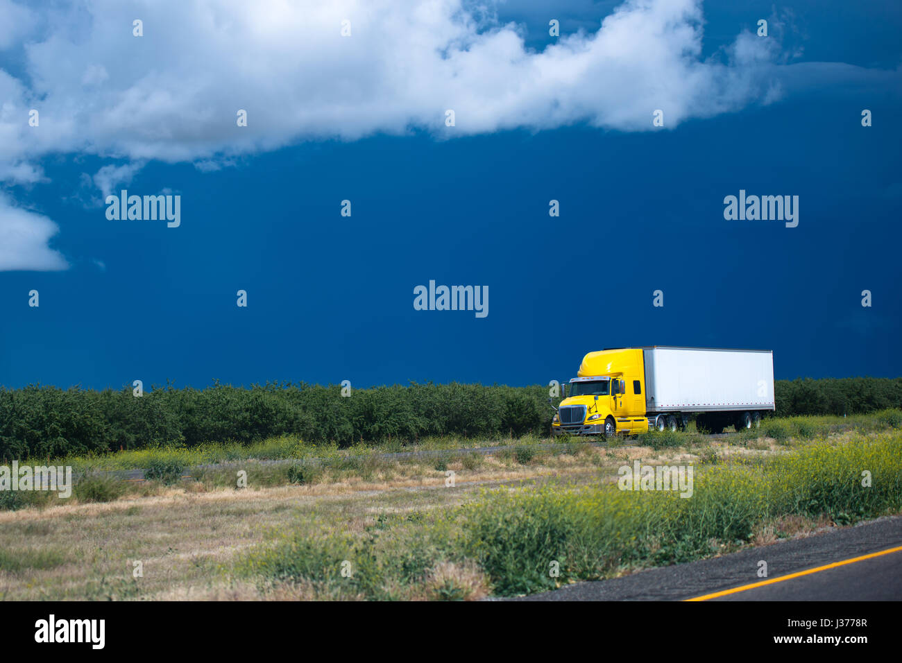 Modern popular comfortable yellow semi truck for long haul going with a