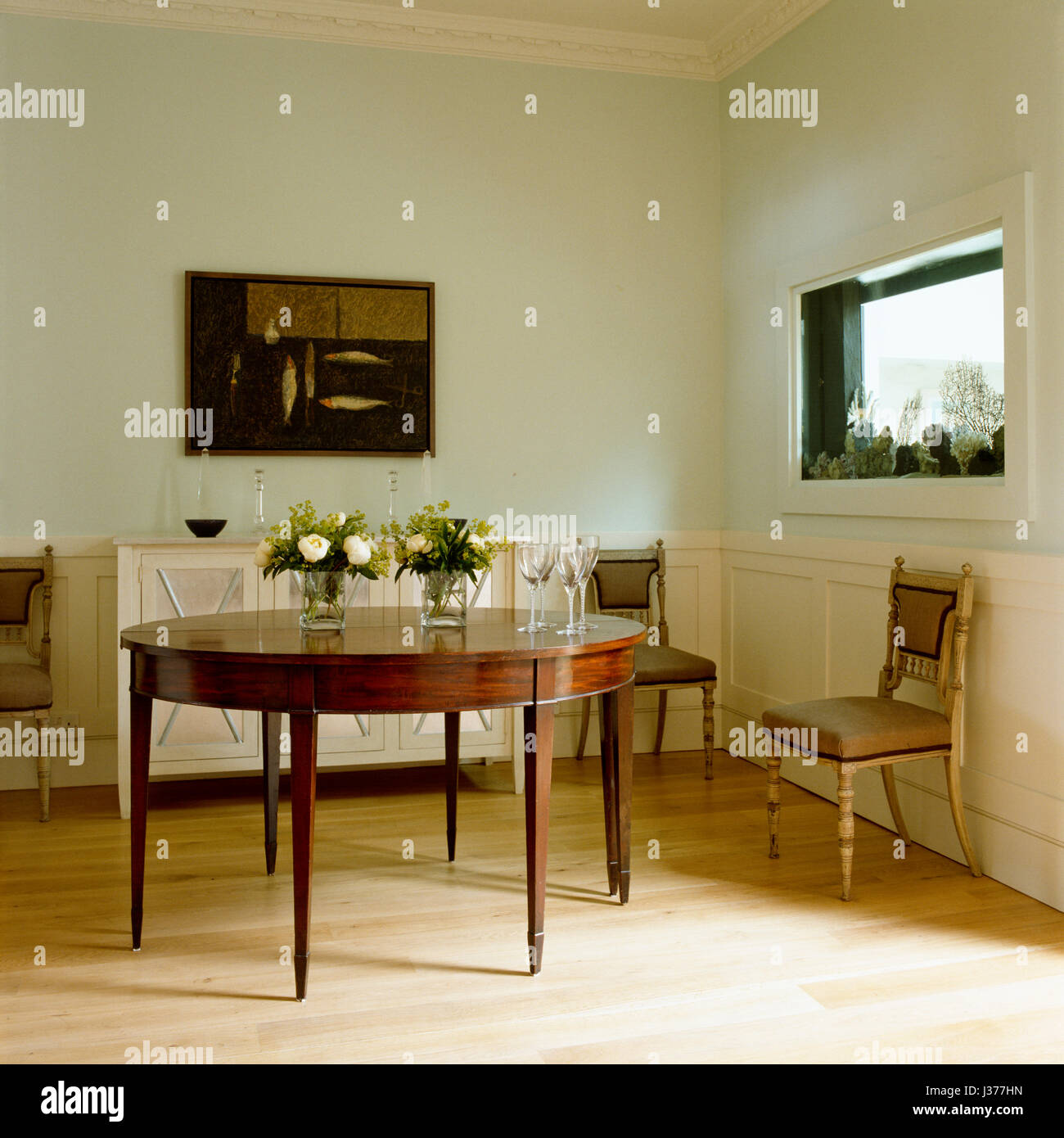 Two classic chairs beside dining table. Stock Photo