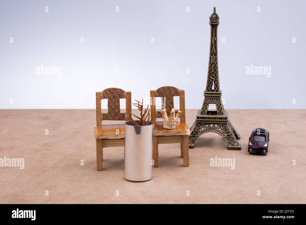 Eiffel Tower and  brown color wooden  toy chairs on brown background Stock Photo
