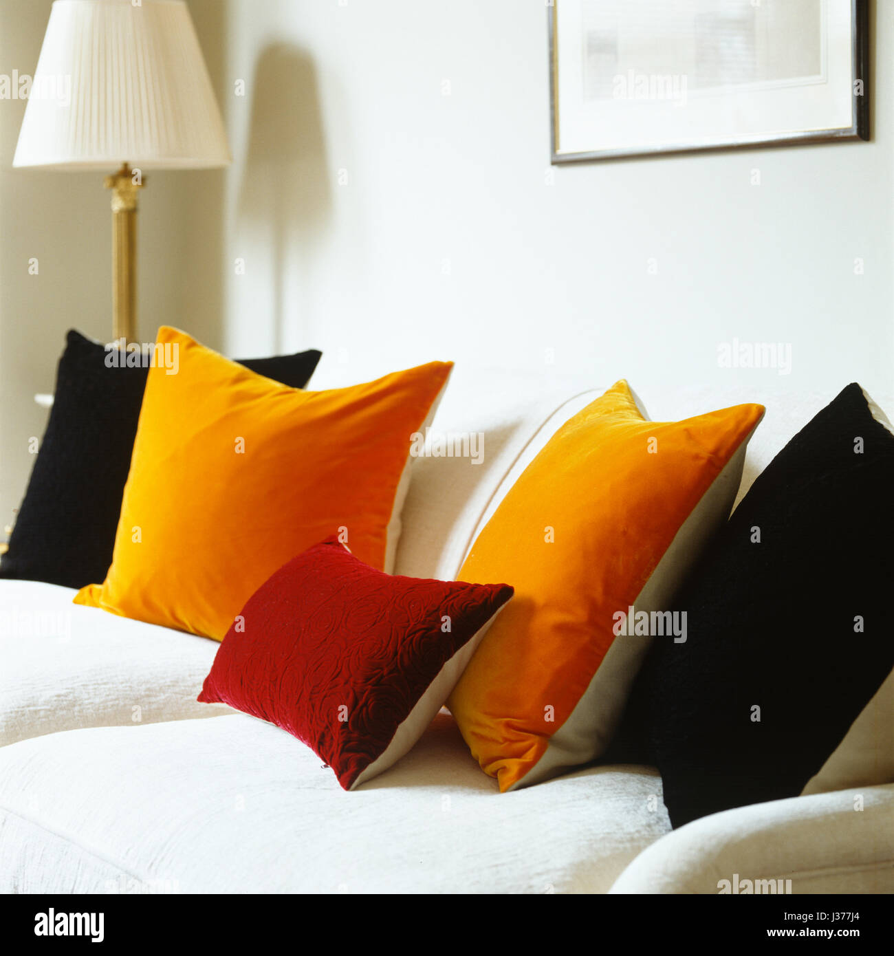 Neutral sofa with bright cushions Stock Photo Alamy