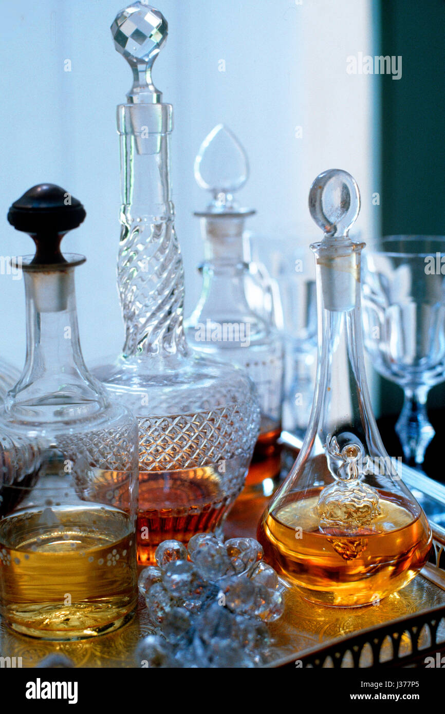 Assorted range of antique bottles with alcohol. Stock Photo