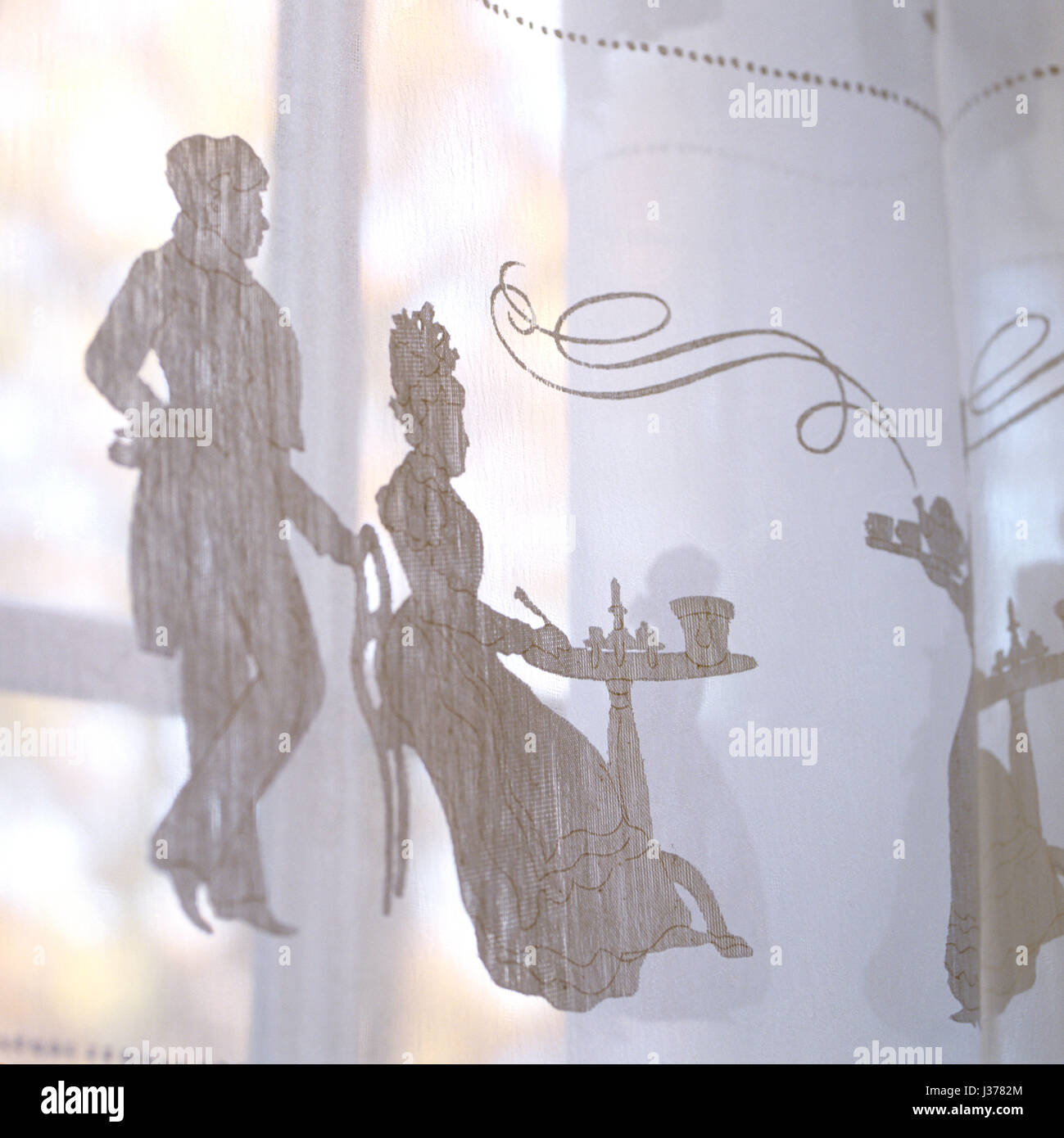 Sheer curtain with illustration of man and woman. Stock Photo