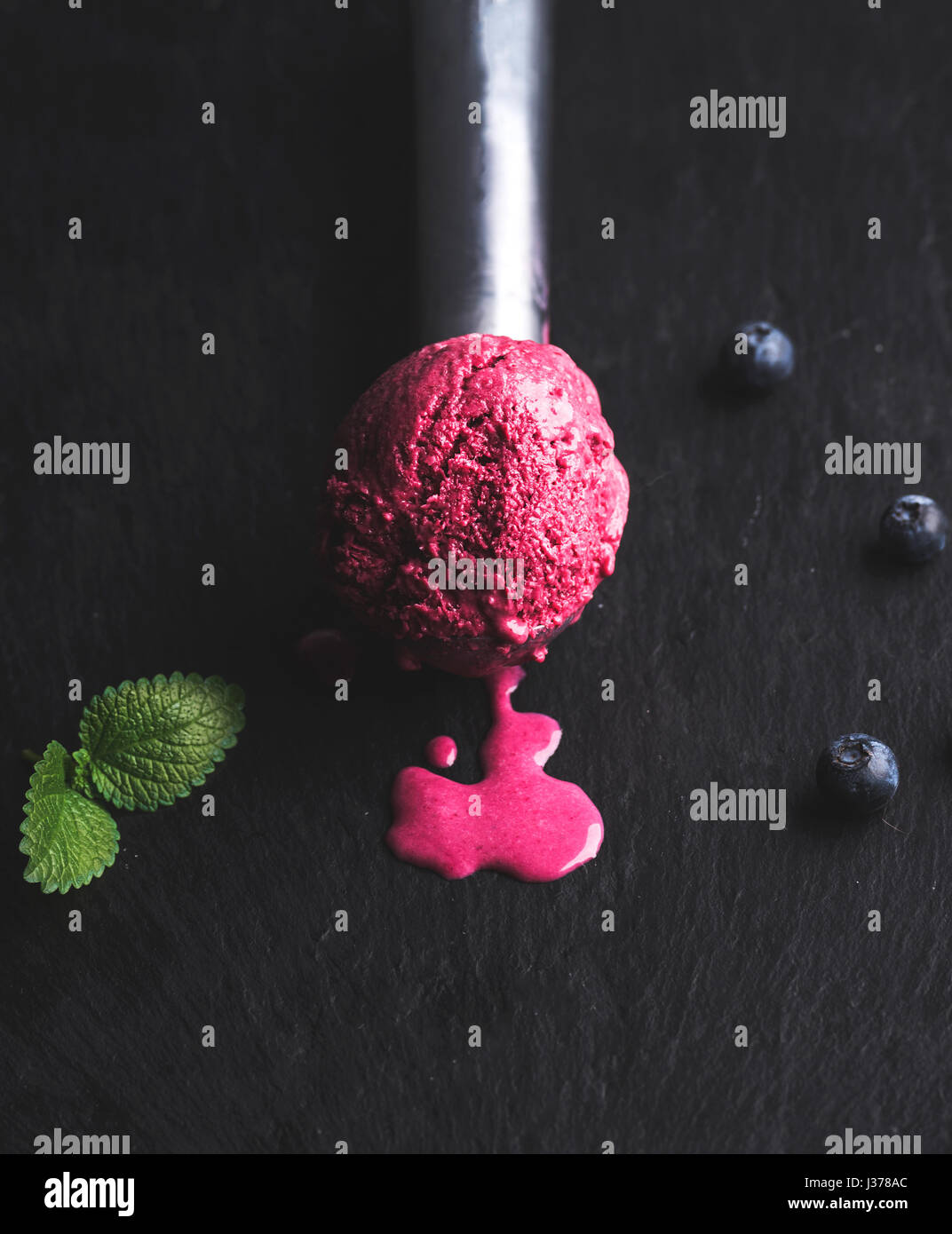 Ice cream melting scoop blueberry hires stock photography and images