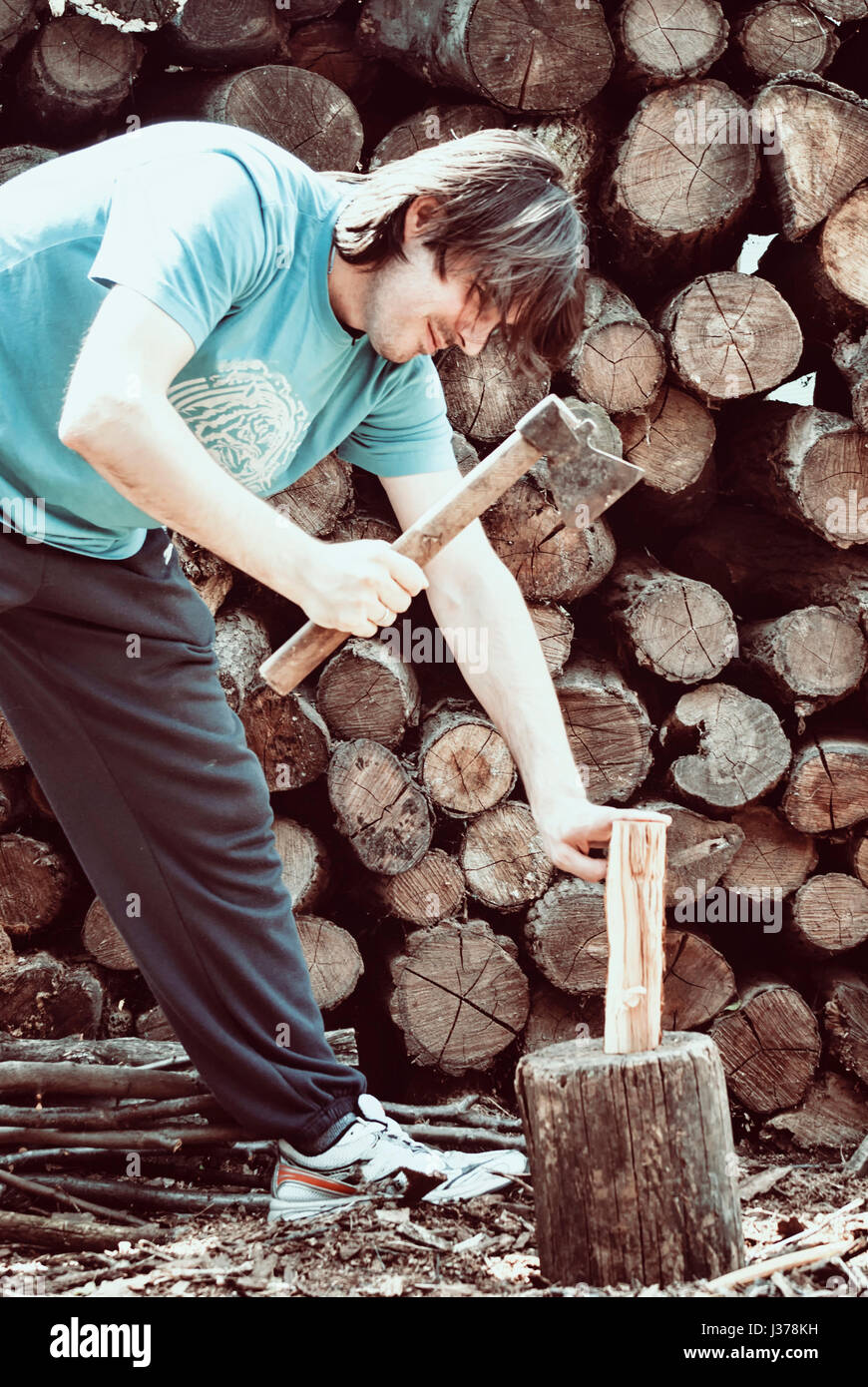 Man choping woods in the yard Stock Photo