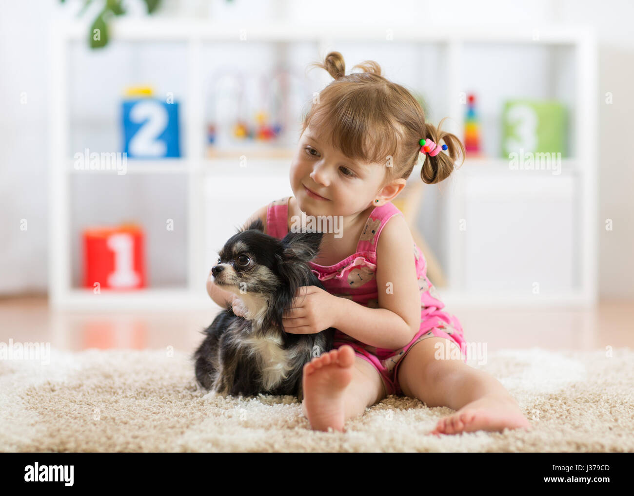 kd and dog play in a nursery Stock Photo
