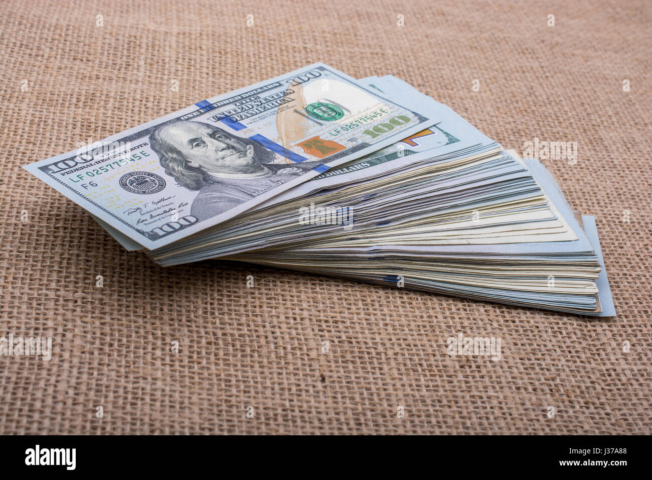 Banknote bundle of US dollar placed on a linen canvas Stock Photo - Alamy