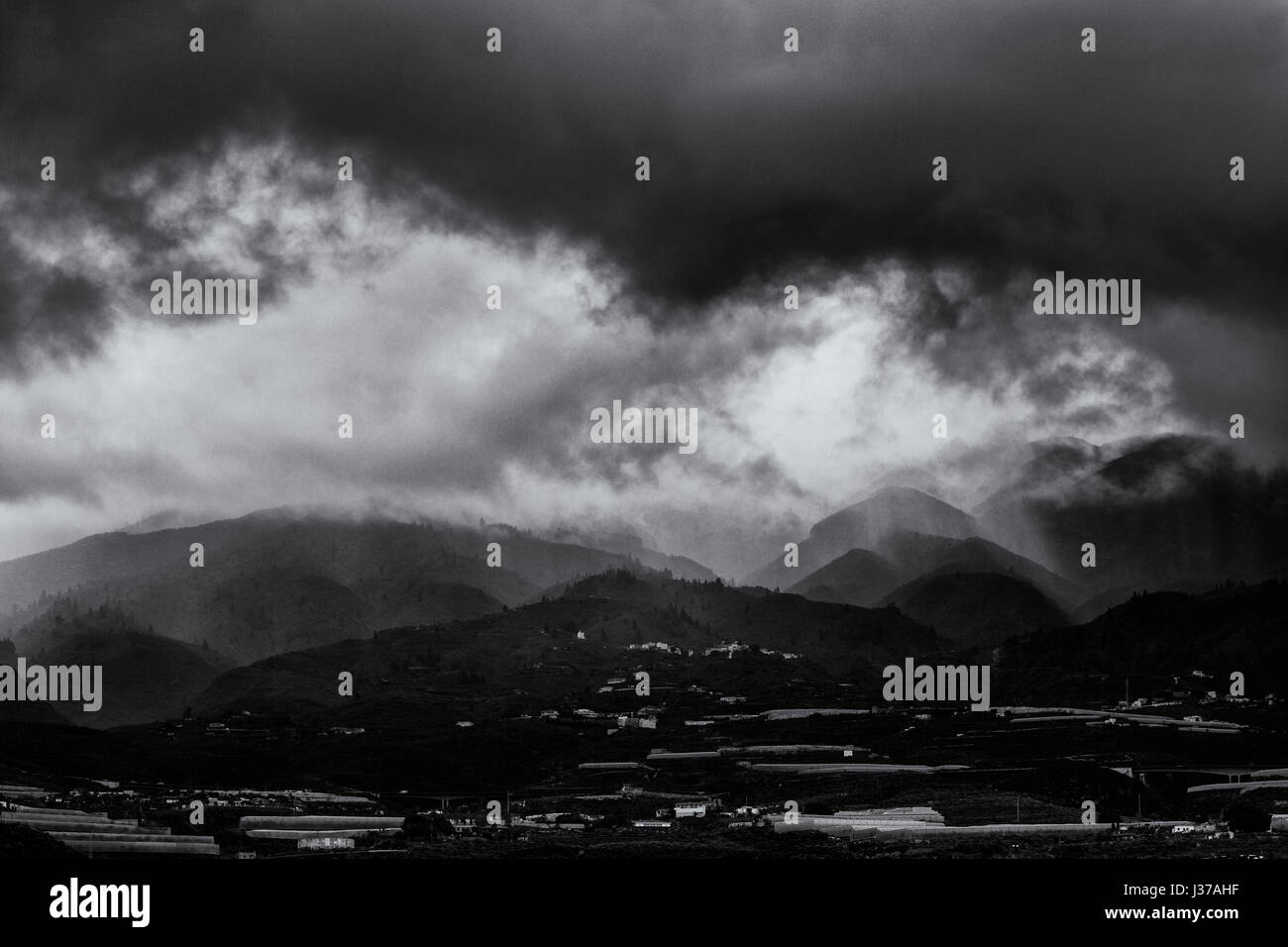 Storm clouds at dawn over the foothills and mountains in Guia de Isora area on the west of Tenerife, Canary Islands, Spain Stock Photo