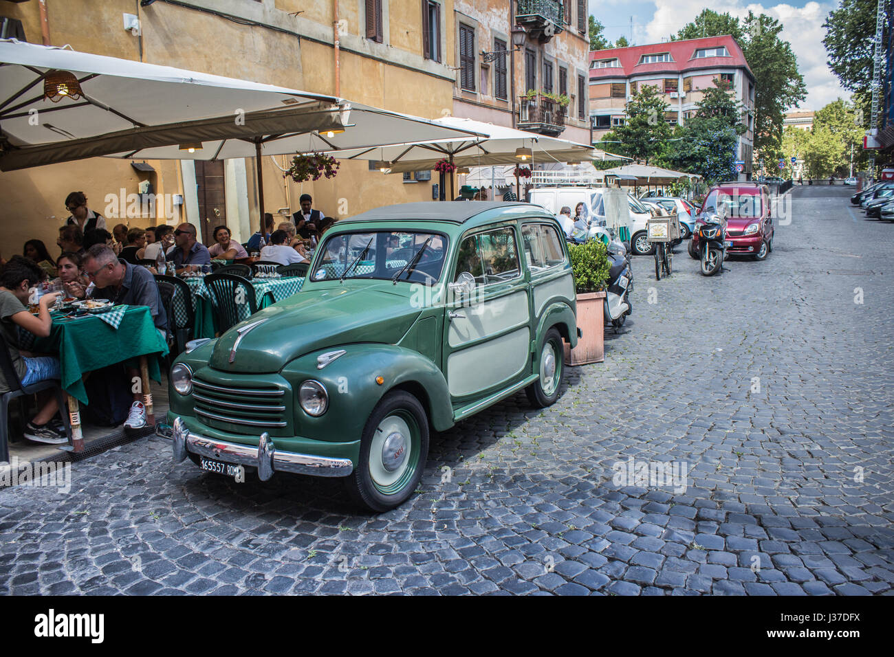 What's not to love?? This old, green car on a side street in Rome was just begging to be taken for a ride. Stock Photo