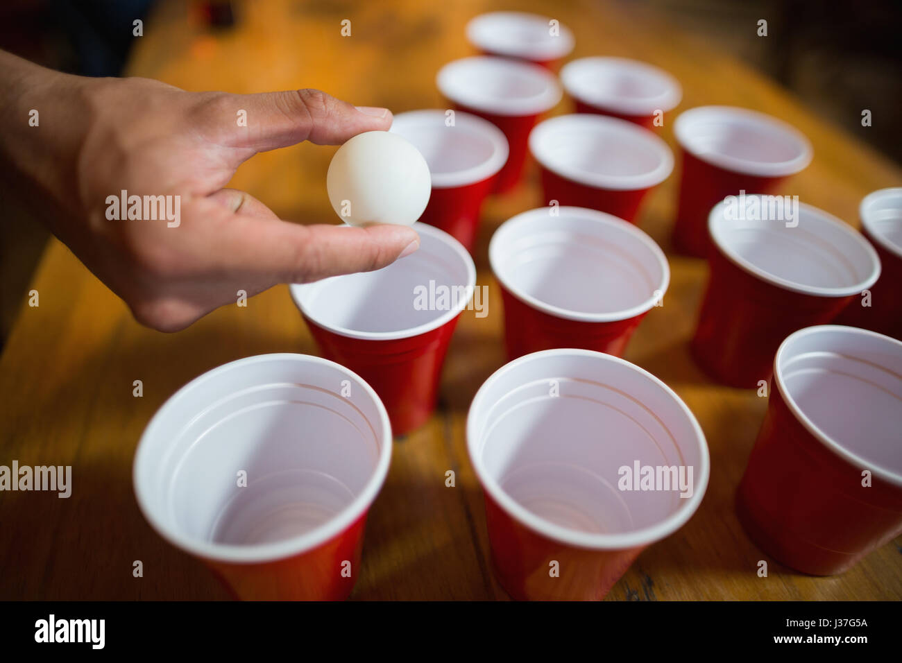 Cropped hand of man playing beer pong in bar Stock Photo - Alamy