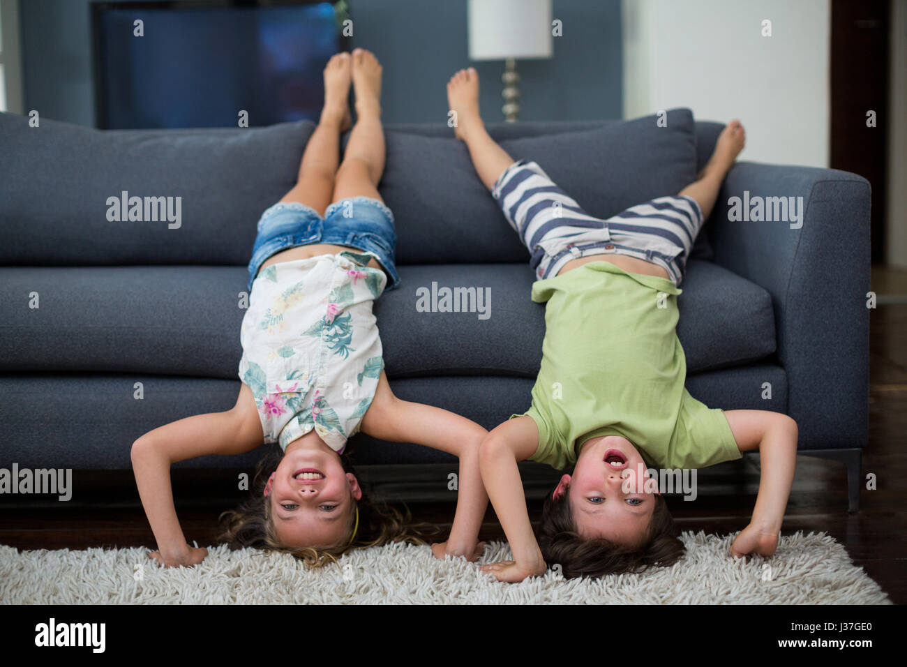Playful siblings having fun in living room at home Stock Photo - Alamy