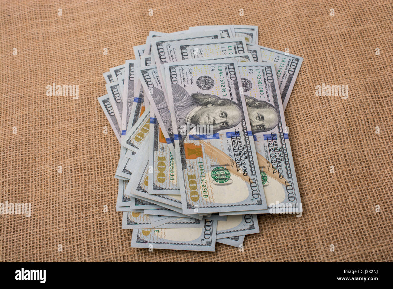 Banknote bundle of US dollar placed on a linen canvas Stock Photo - Alamy