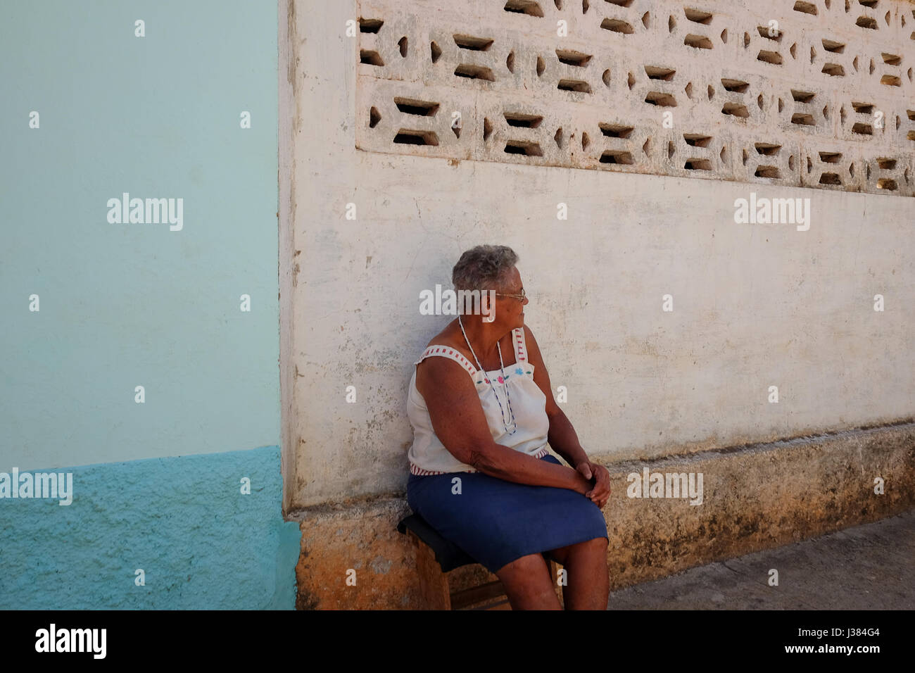 Local cuban woman sitting in front of her home in Havana, Cuba Stock Photo