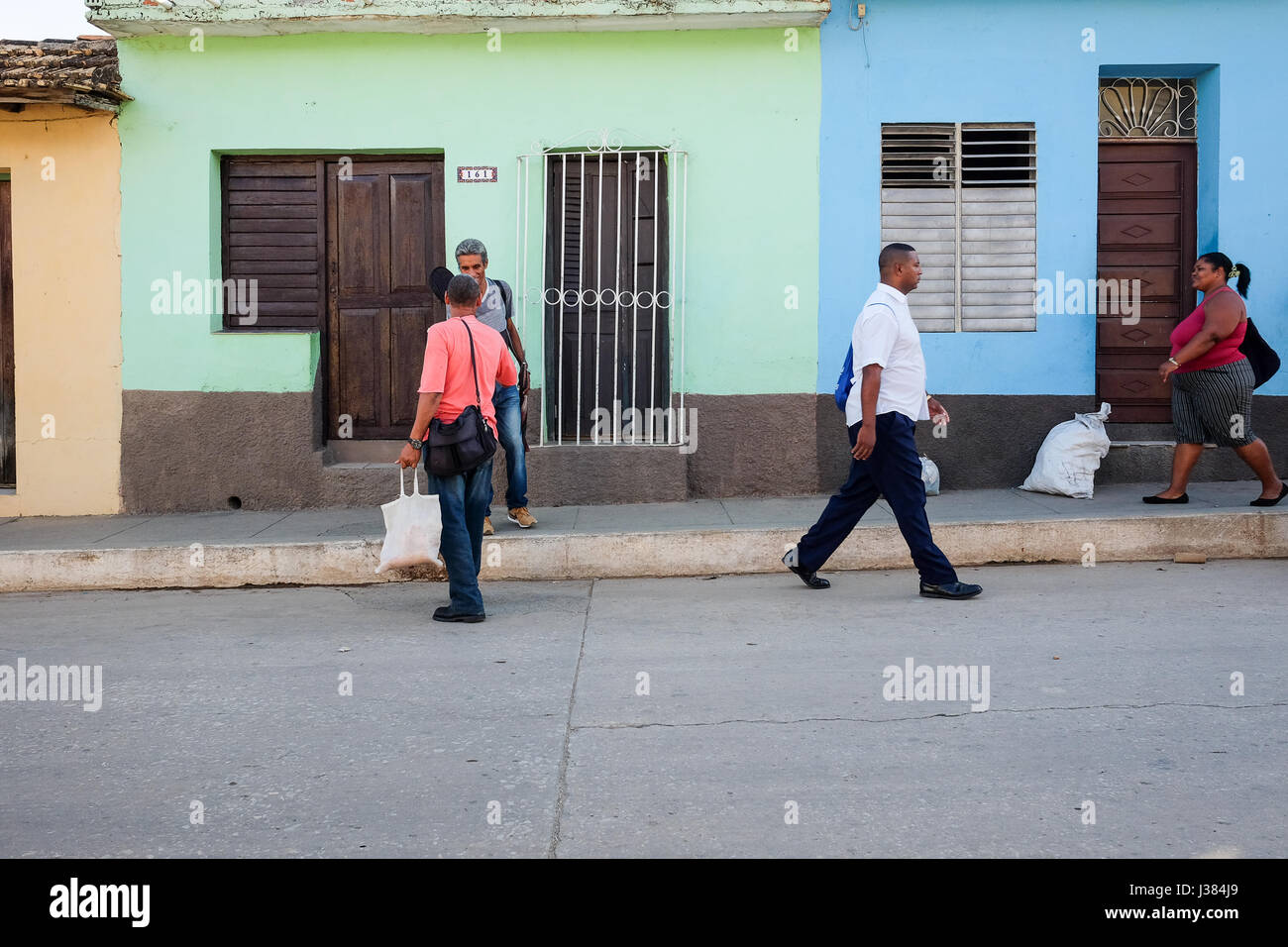 Local street life in Trinidad, Sancti Spiritus, Cuba. Persons passing by. Stock Photo
