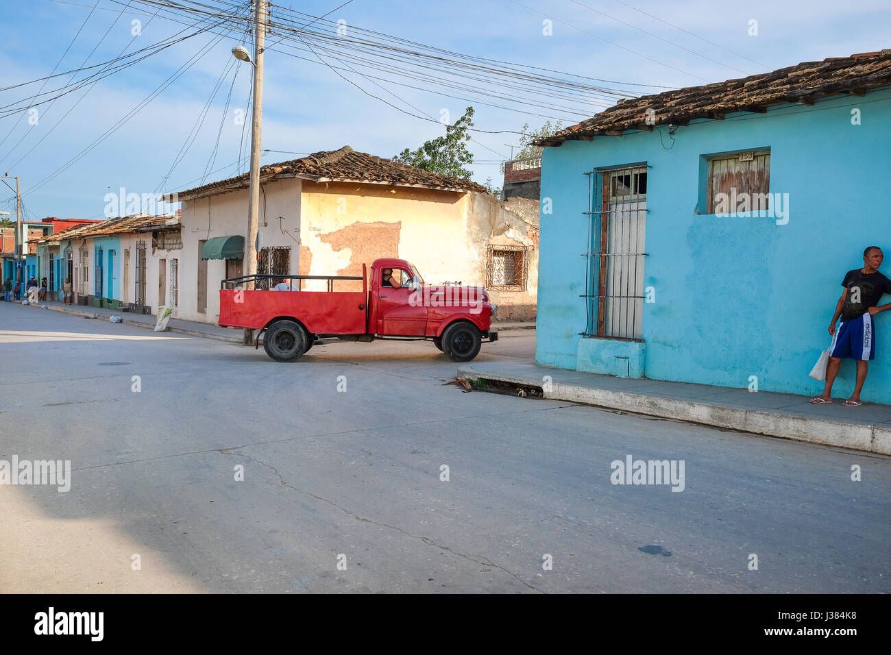 streets of trinidad, Cuba, red pickup driving by Stock Photo