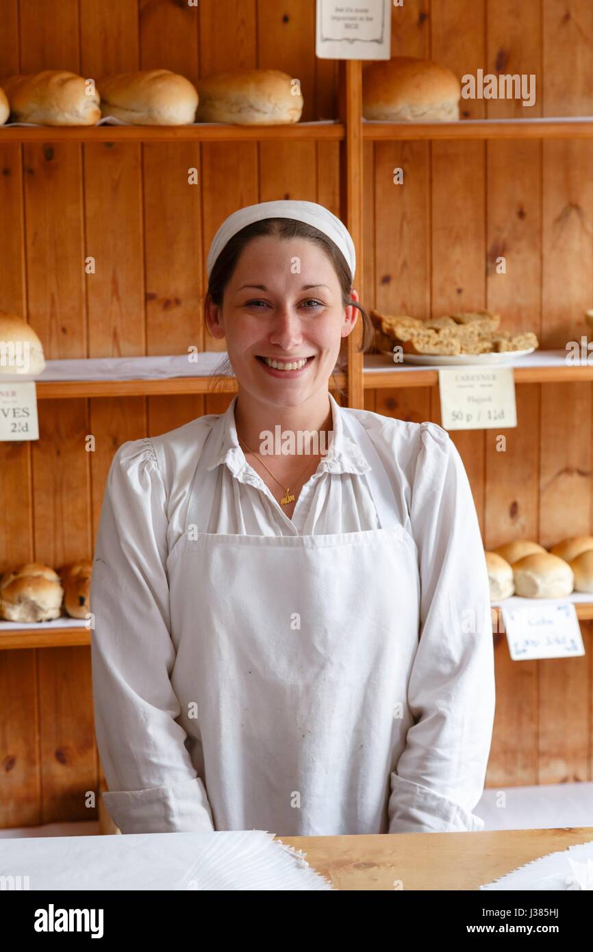 Woman baker at the Victorian Bakery shop store in Blists Hill Museum, Ironbridge, Shropshire, UK Stock Photo