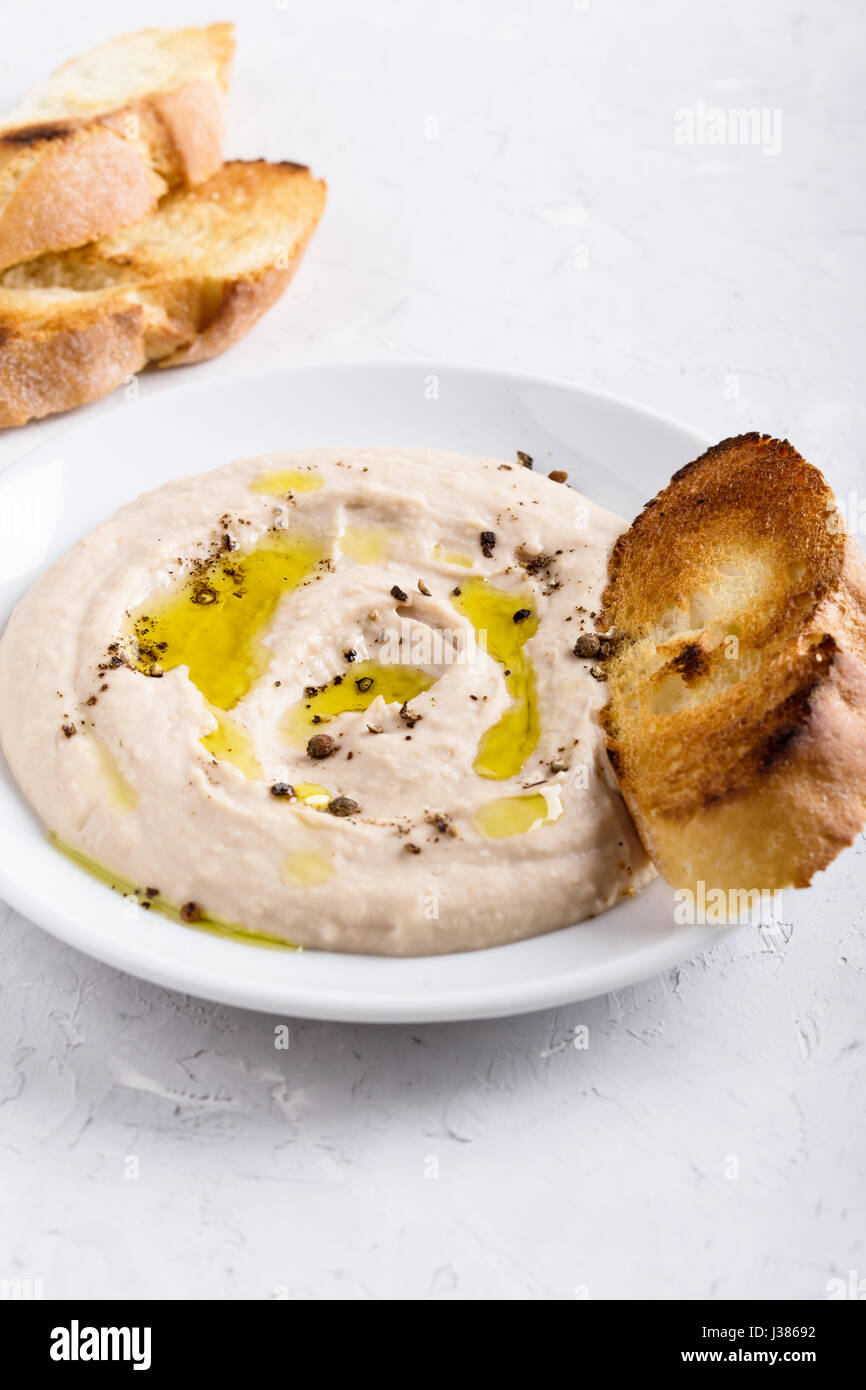 White bean dip on plate, vegan pate side dish, delicious appetizer, snack, or party spread Stock